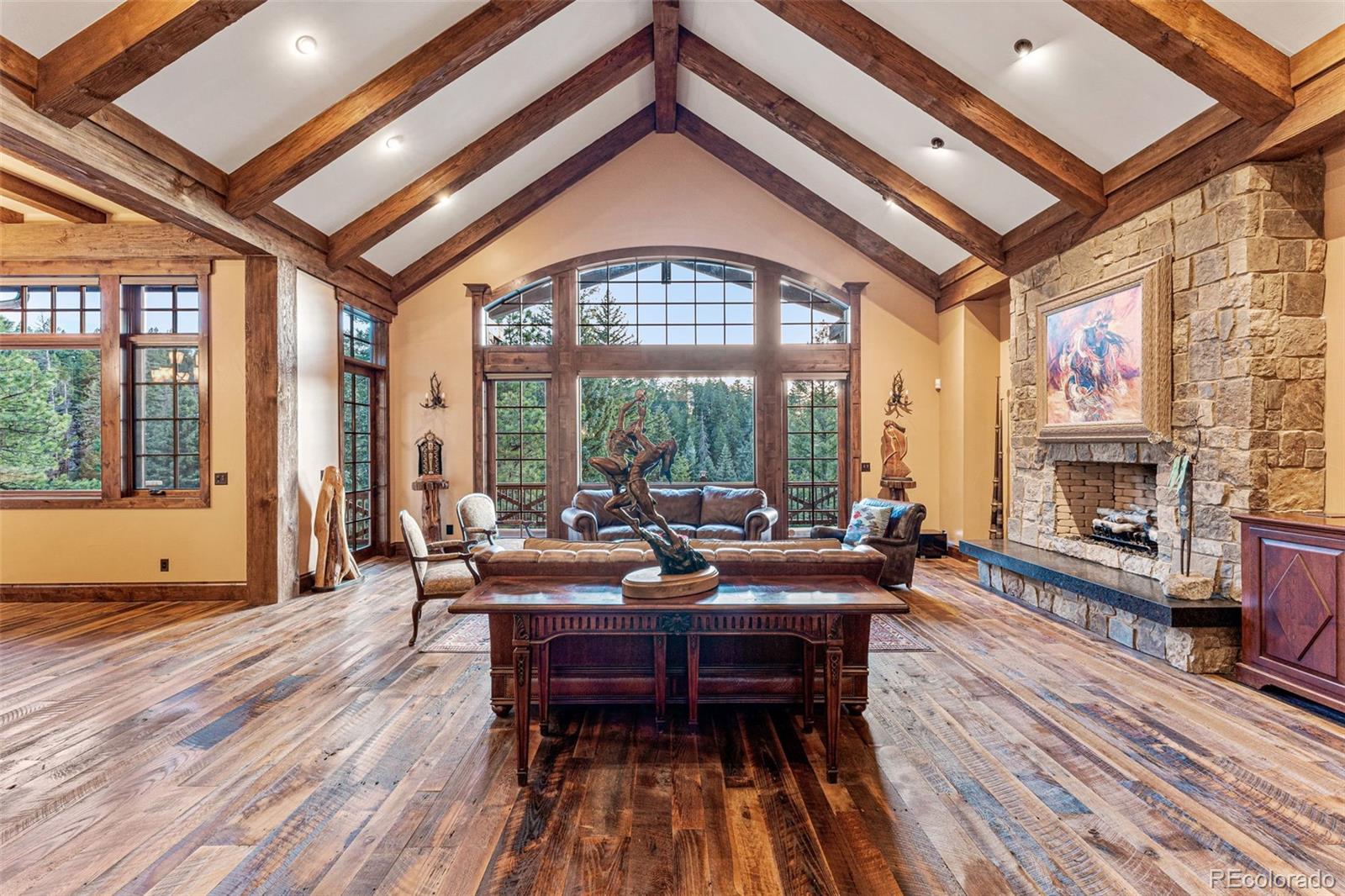 30 West Ranch Trail Morrison, CO 80465 - Photo 5 of 50 a living room with furniture a fireplace and floor to ceiling windows