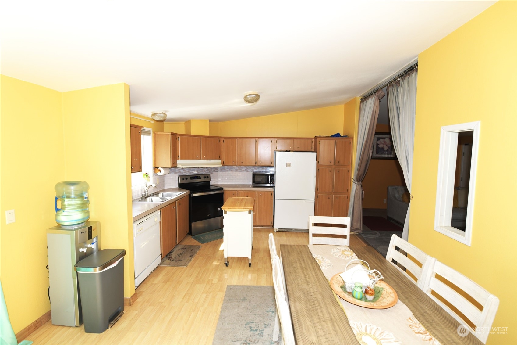 7701 Hardeson Road, Unit 54B Everett, WA 98203 - Photo 8 of 15 a living room with stainless steel appliances furniture a rug and a kitchen view