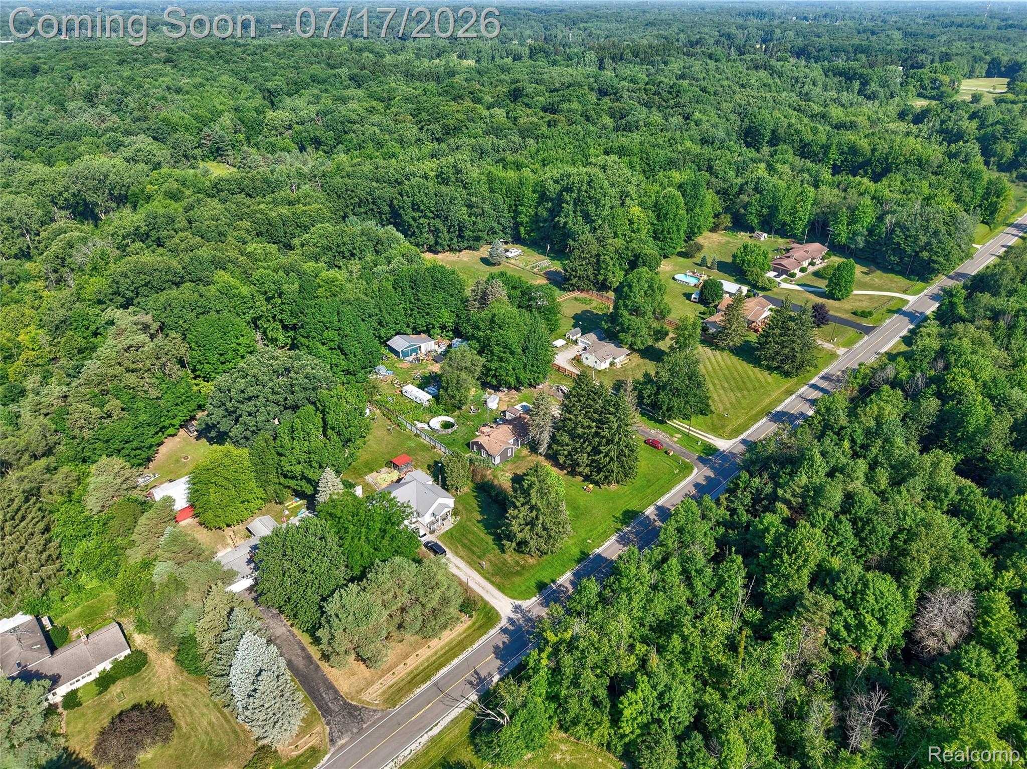 11255 North Center Road Clio, MI 48420 - Photo 32 of 37 Expansive aerial view showcasing a large residential parcel bordered by mature trees and verdant landscapes