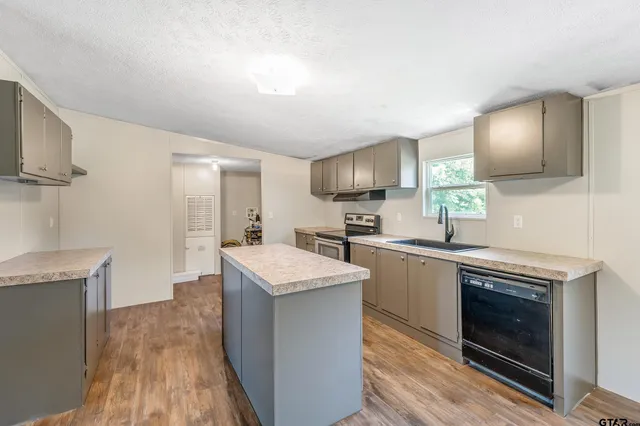 a kitchen with a sink stove and refrigerator