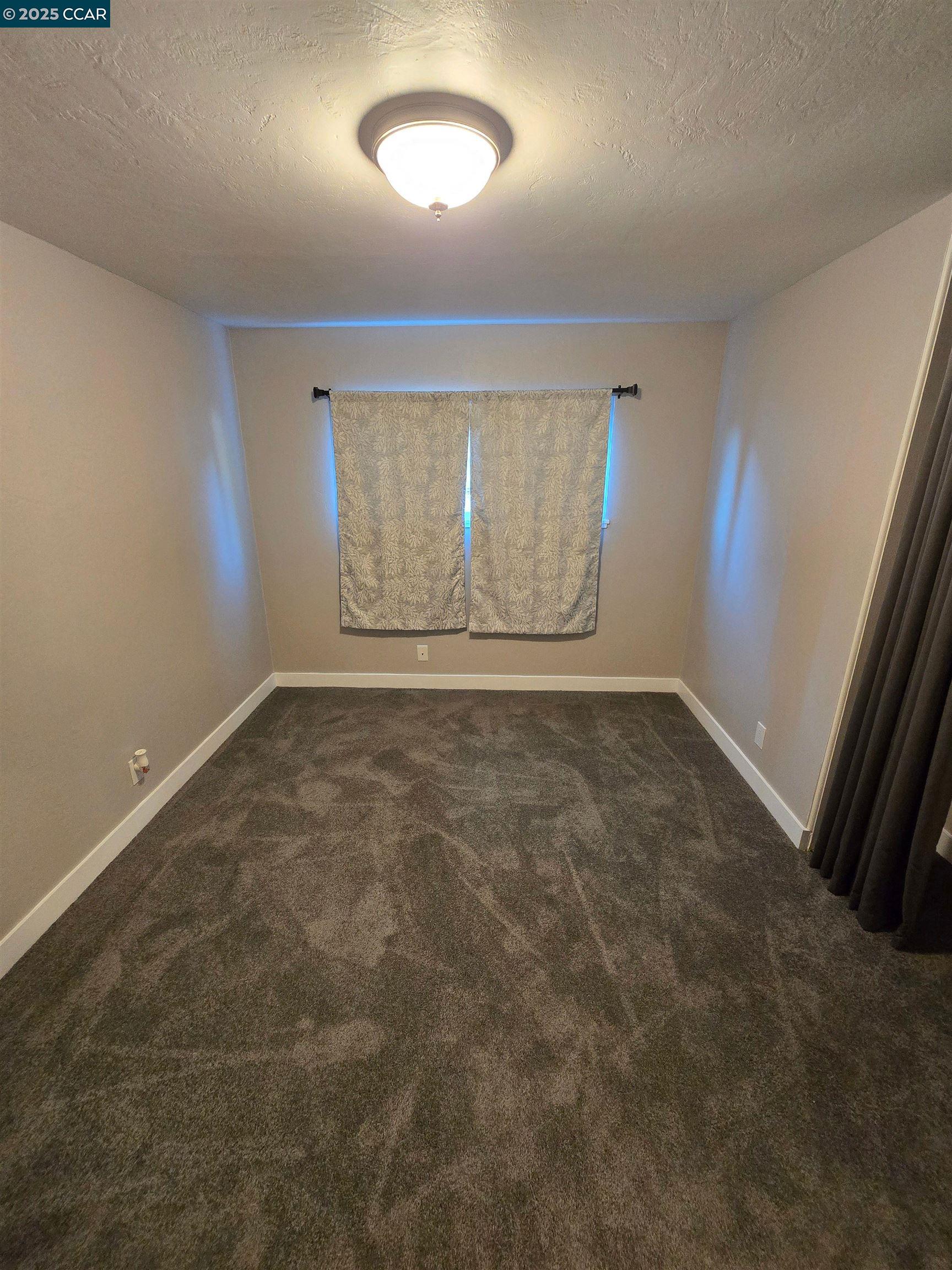 4370 Harmon Road El Sobrante, CA 94803 - Photo 4 of 10 an empty room with windows