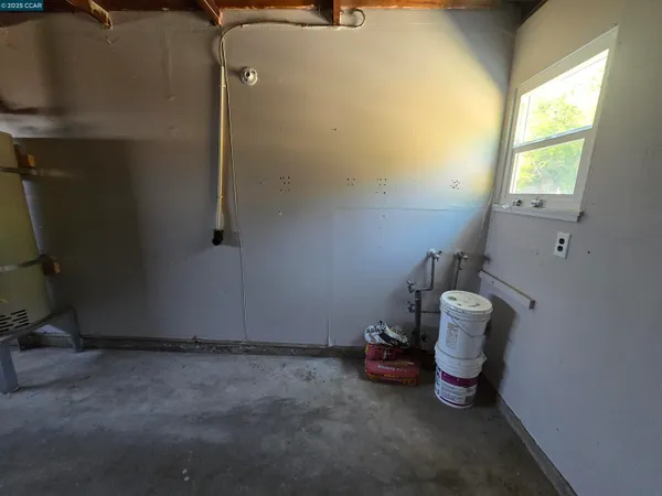a view of a room with wooden floor and a window