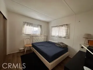 a bed sitting in a bedroom next to a window