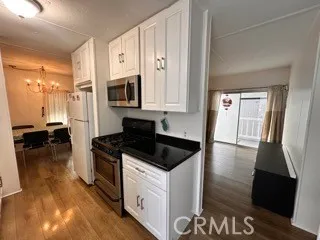 a kitchen with granite countertop a stove a sink and a granite counter top