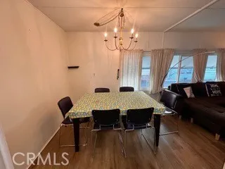 a view of a room with furniture and wooden floor