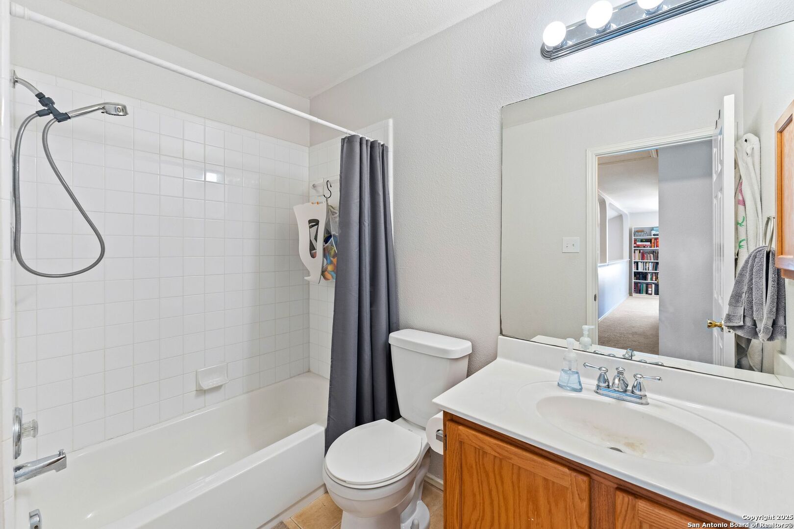 10611 Apple Spring Universal City, TX 78148 - Photo 11 of 29 a bathroom with a sink toilet and shower