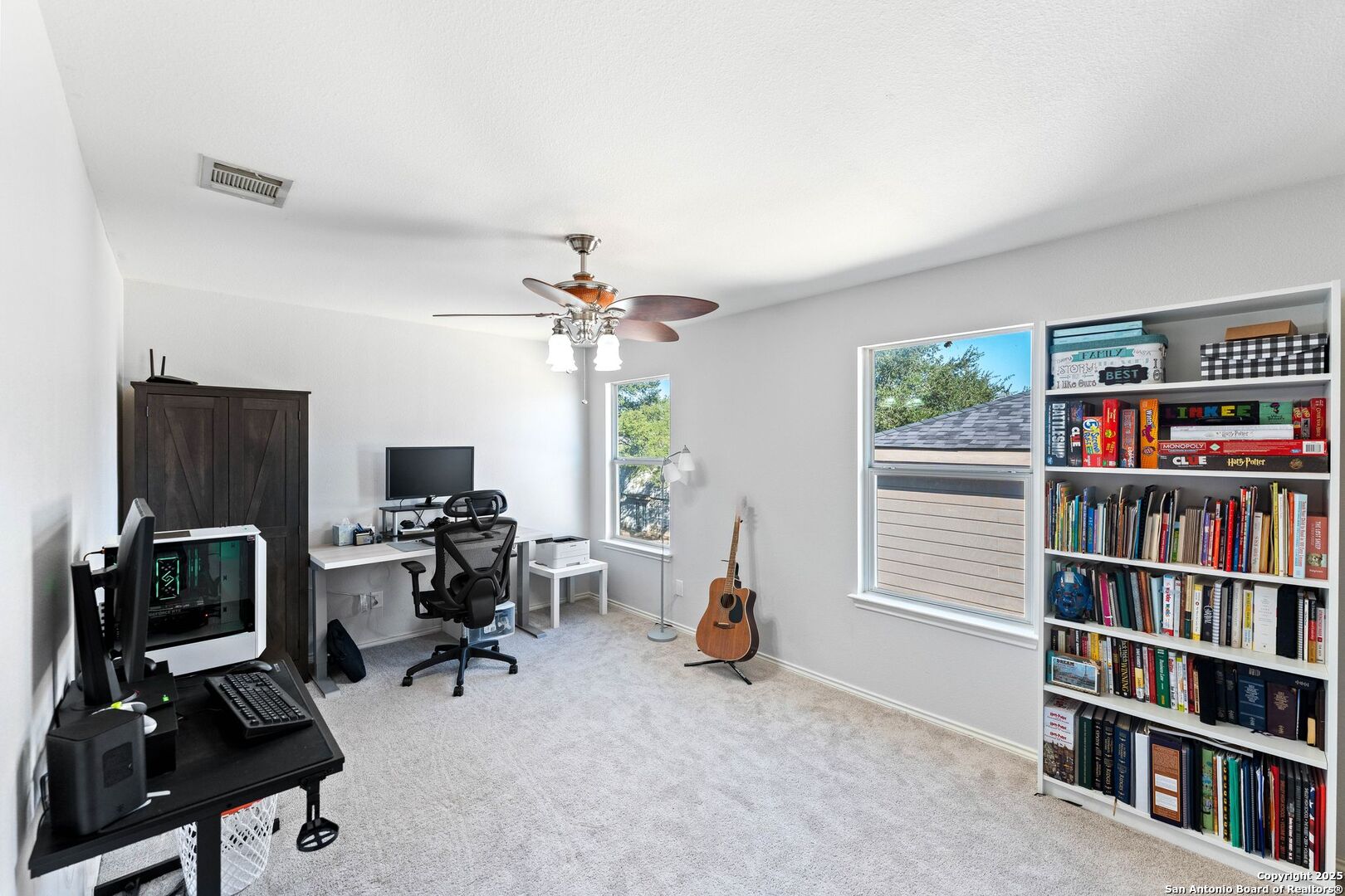 10611 Apple Spring Universal City, TX 78148 - Photo 17 of 29 a view of a workspace with furniture and a book shelf