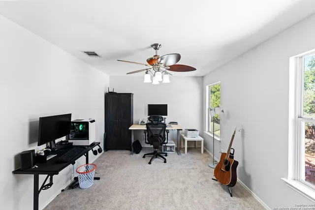 a living room with furniture a flat screen tv and a window