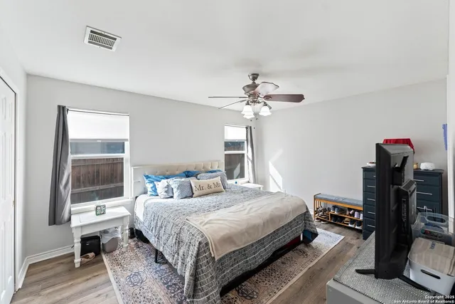 a bedroom with a bed and wooden floor