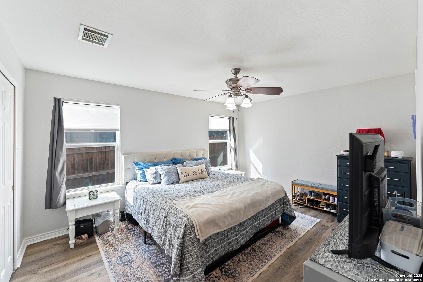 10611 Apple Spring Universal City, TX 78148 - Photo 20 of 29 a bedroom with a bed and wooden floor