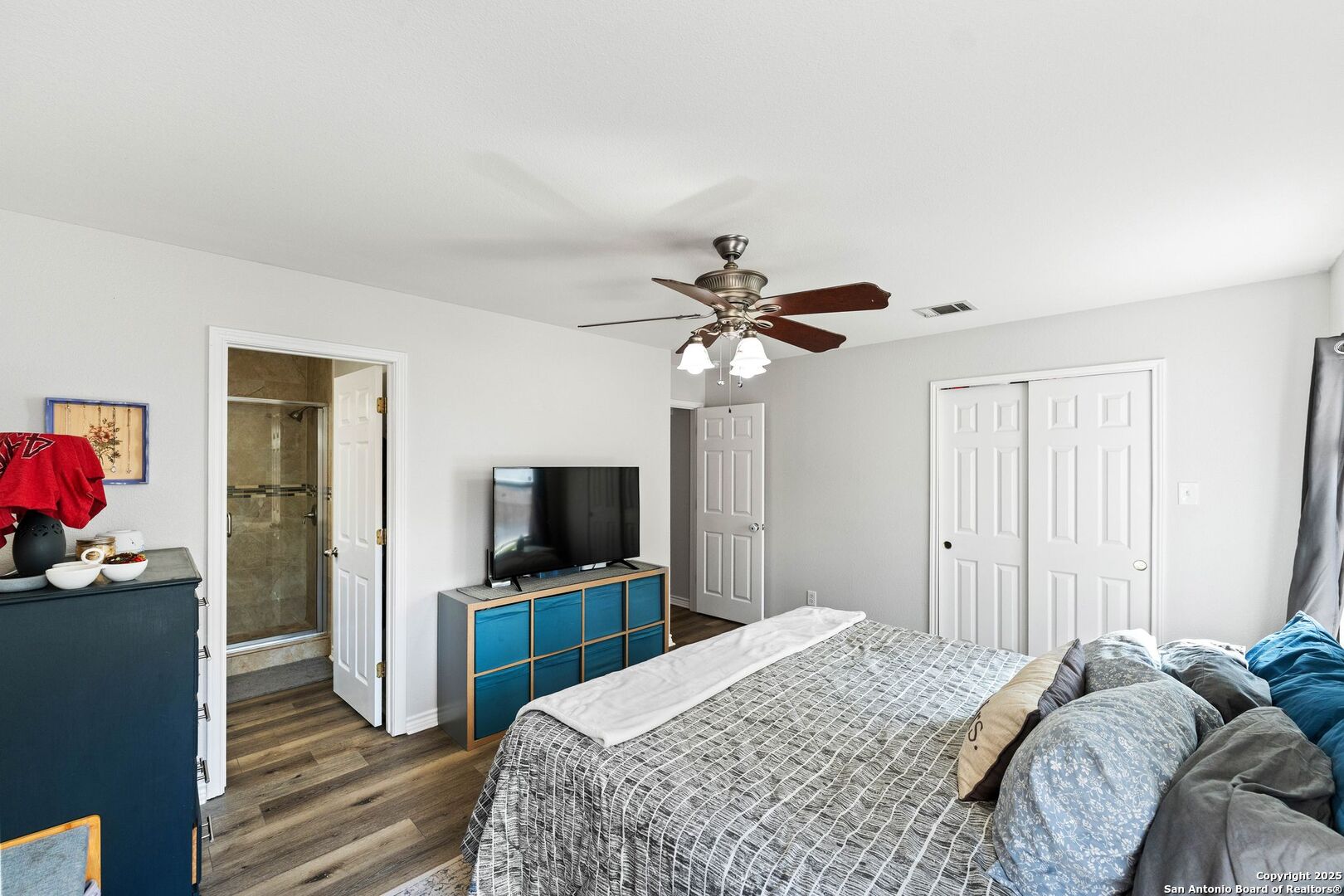 10611 Apple Spring Universal City, TX 78148 - Photo 21 of 29 a bedroom with a bed and a flat screen tv