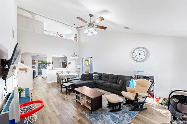 a living room with furniture a rug and a chandelier