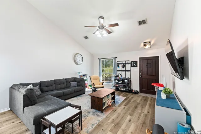 a living room with furniture and a flat screen tv