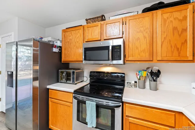 a kitchen with stainless steel appliances a stove a microwave and a sink