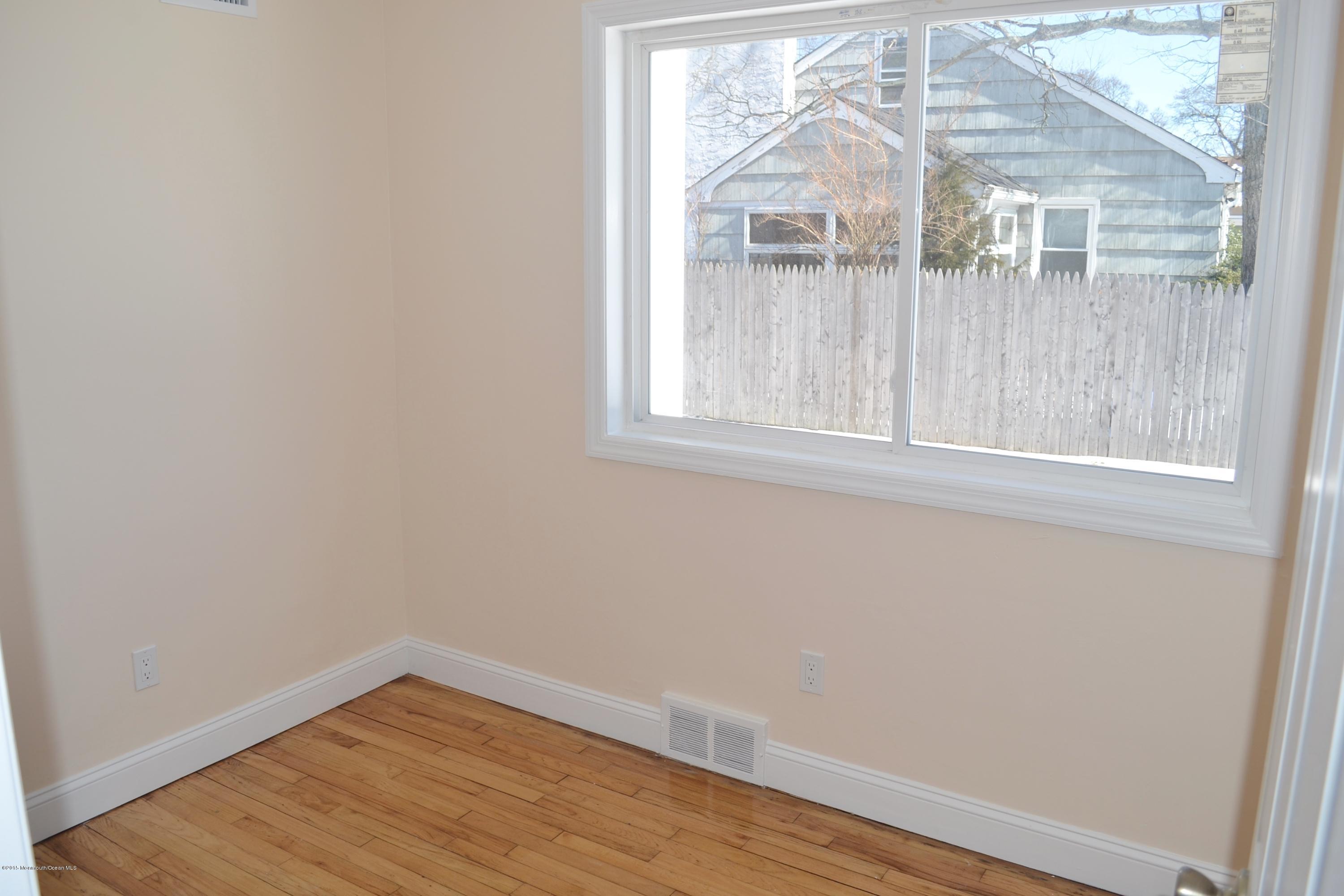 1000 Beaver Dam Road Point Pleasant, NJ 08742 - Photo 14 of 32 a view of a small space with wooden floor and a window