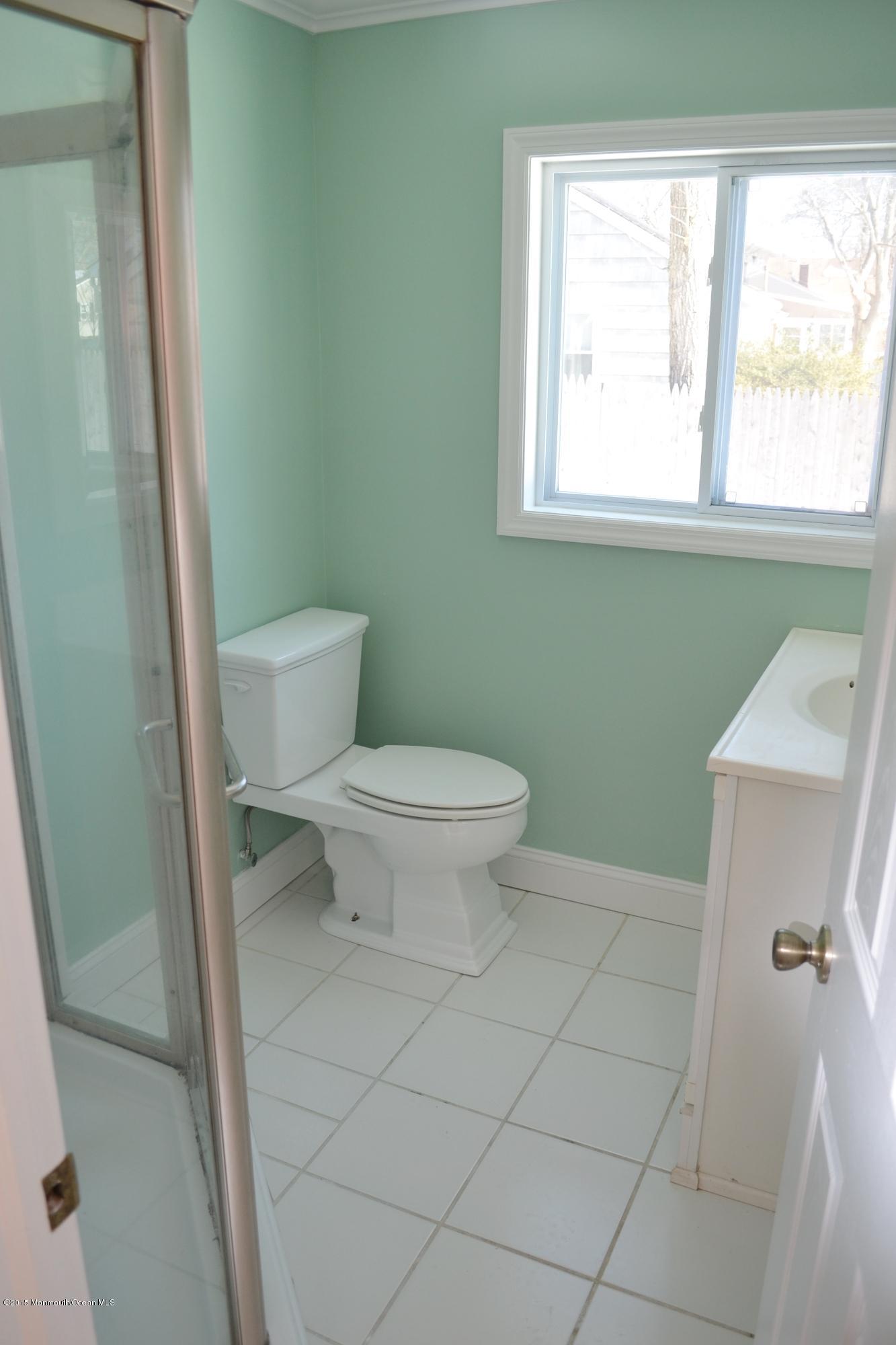 1000 Beaver Dam Road Point Pleasant, NJ 08742 - Photo 15 of 32 a bathroom with a toilet a sink and a window