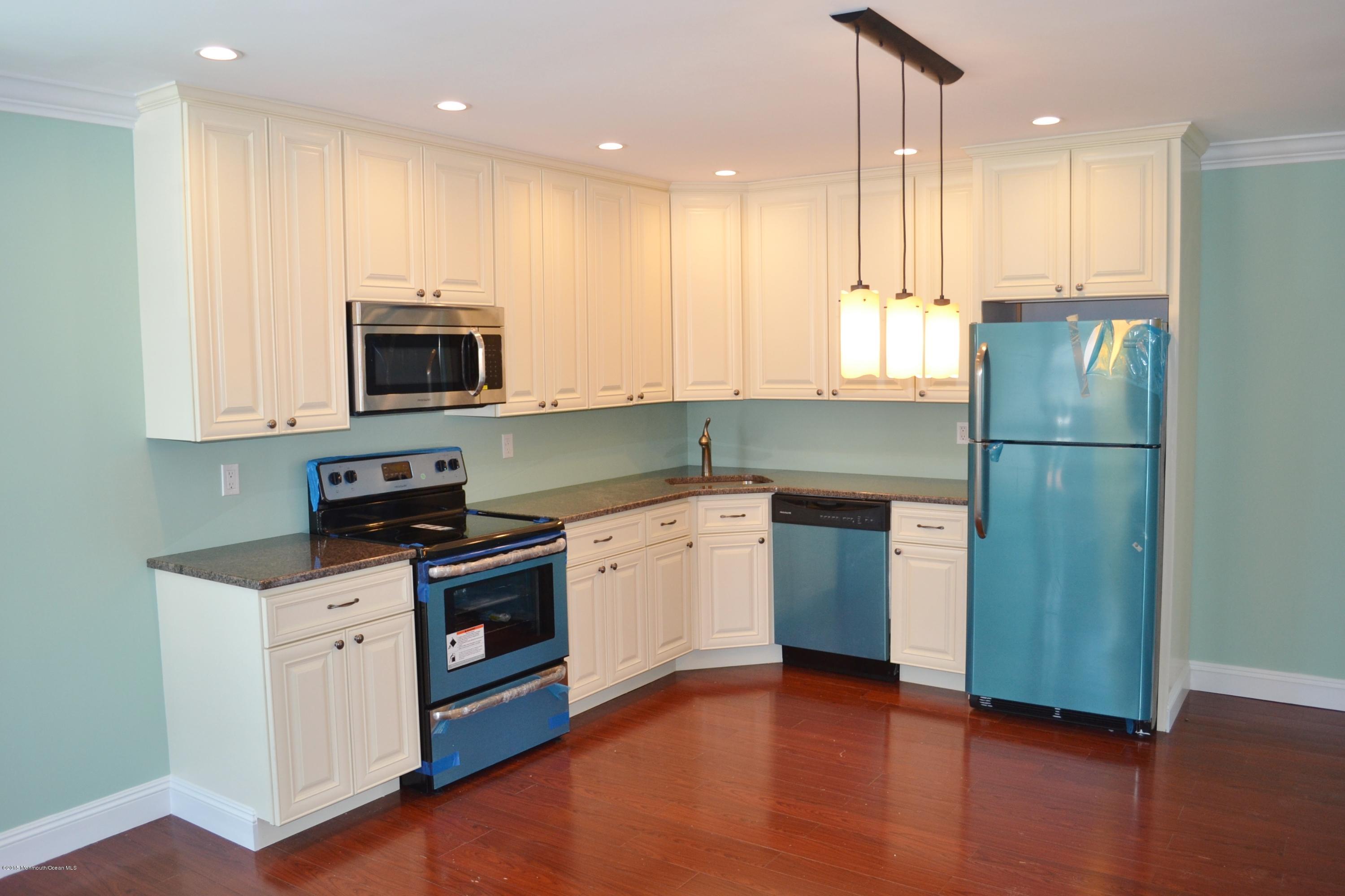 1000 Beaver Dam Road Point Pleasant, NJ 08742 - Photo 18 of 32 a kitchen with stainless steel appliances granite countertop a refrigerator a stove a sink and a microwave