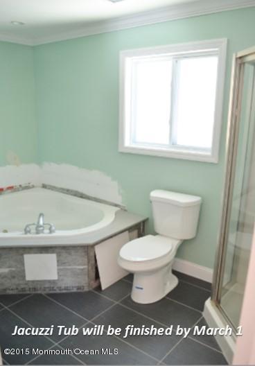 1000 Beaver Dam Road Point Pleasant, NJ 08742 - Photo 25 of 32 a bathroom with a sink a toilet and a window