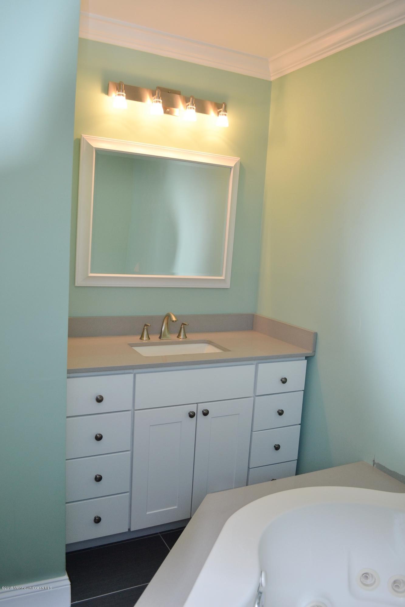 1000 Beaver Dam Road Point Pleasant, NJ 08742 - Photo 26 of 32 a bathroom with a sink and a mirror