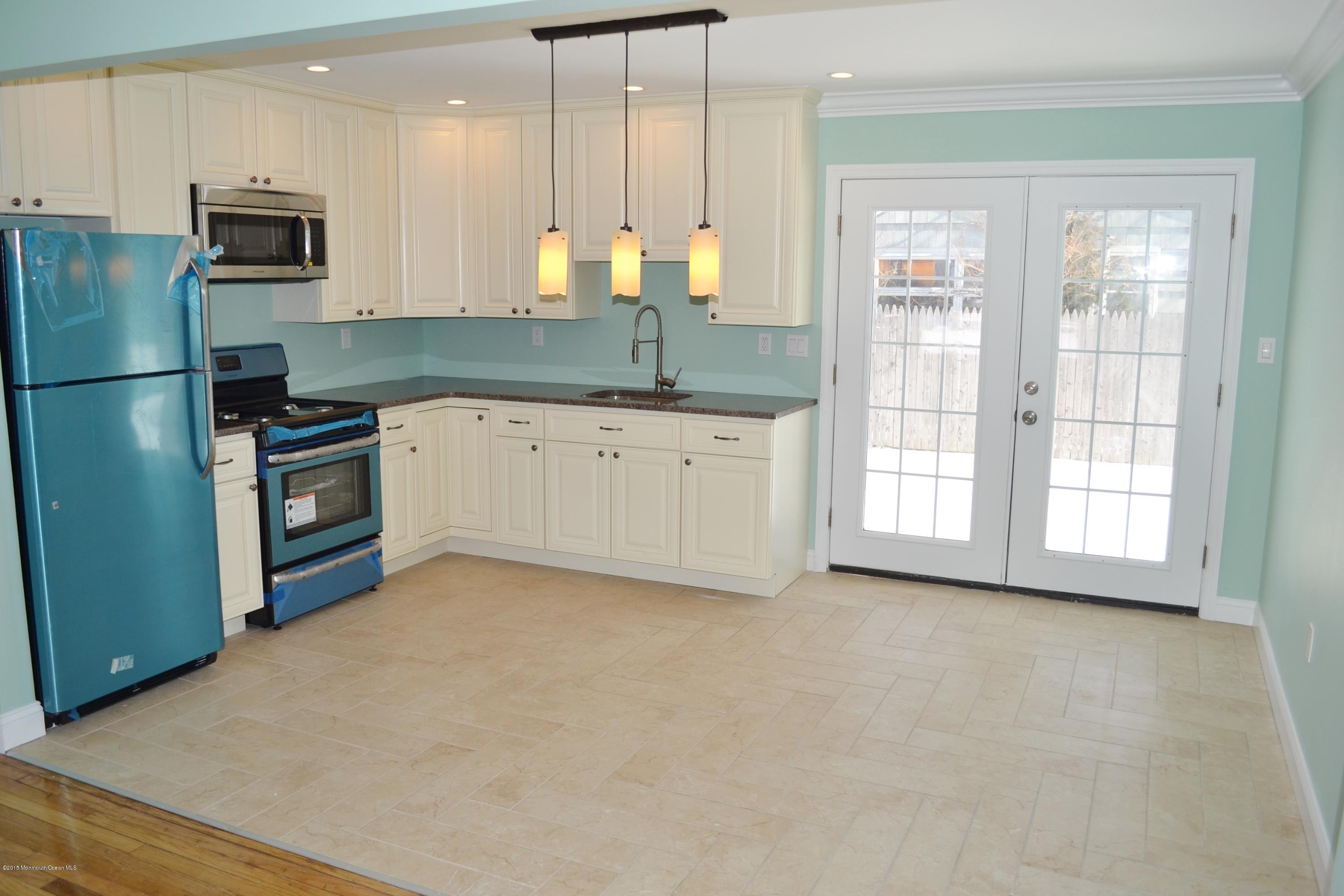 1000 Beaver Dam Road Point Pleasant, NJ 08742 - Photo 7 of 32 a kitchen with stainless steel appliances granite countertop a refrigerator a sink a stove and white cabinets