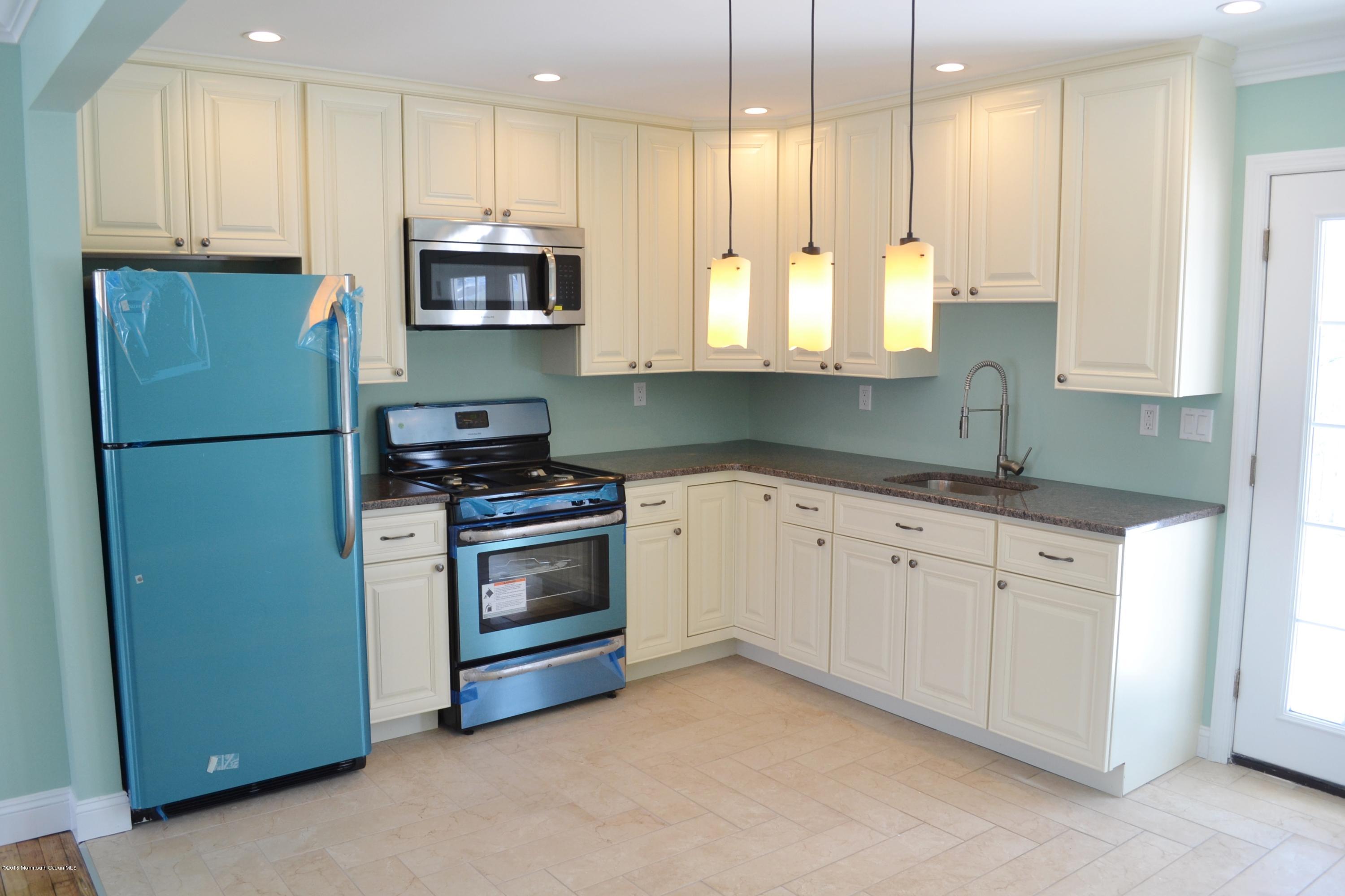 1000 Beaver Dam Road Point Pleasant, NJ 08742 - Photo 8 of 32 a kitchen with granite countertop white cabinets and stainless steel appliances