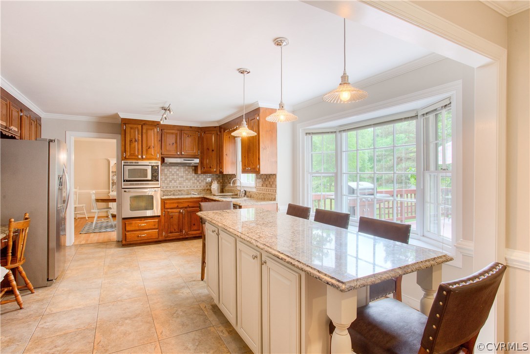 13641 Glendower Road Midlothian, VA 23113 - Photo 14 of 38 a kitchen with stainless steel appliances granite countertop a stove top oven a sink dishwasher a dining table and chairs with wooden floor