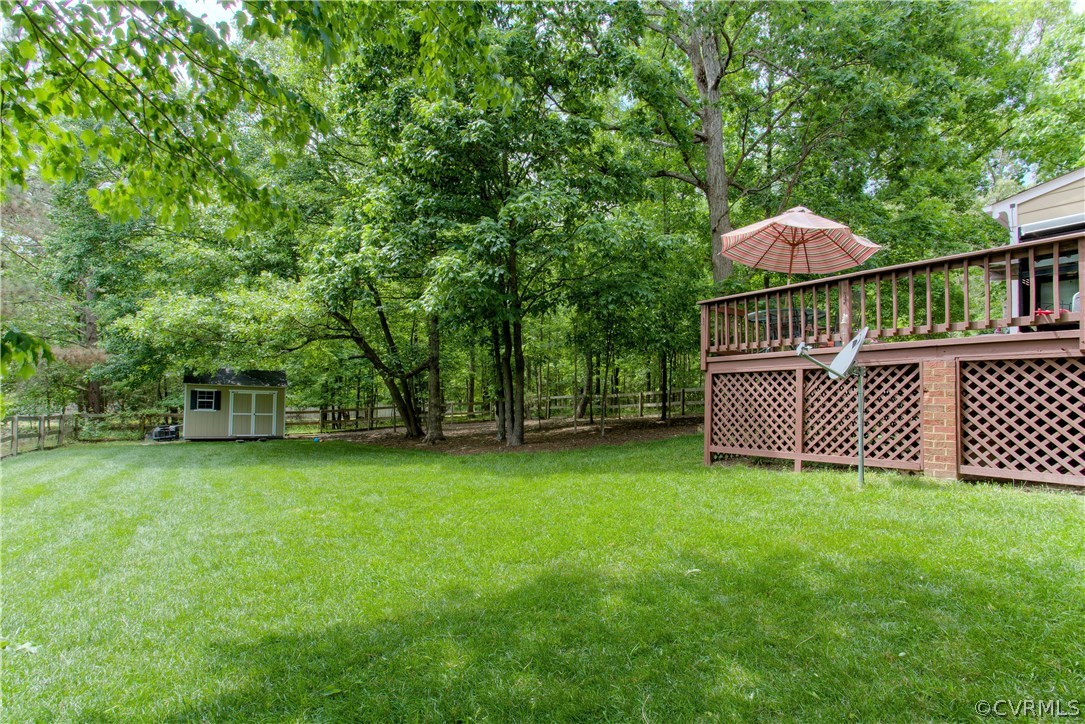 13641 Glendower Road Midlothian, VA 23113 - Photo 36 of 38 a view of a deck with a large tree and wooden fence