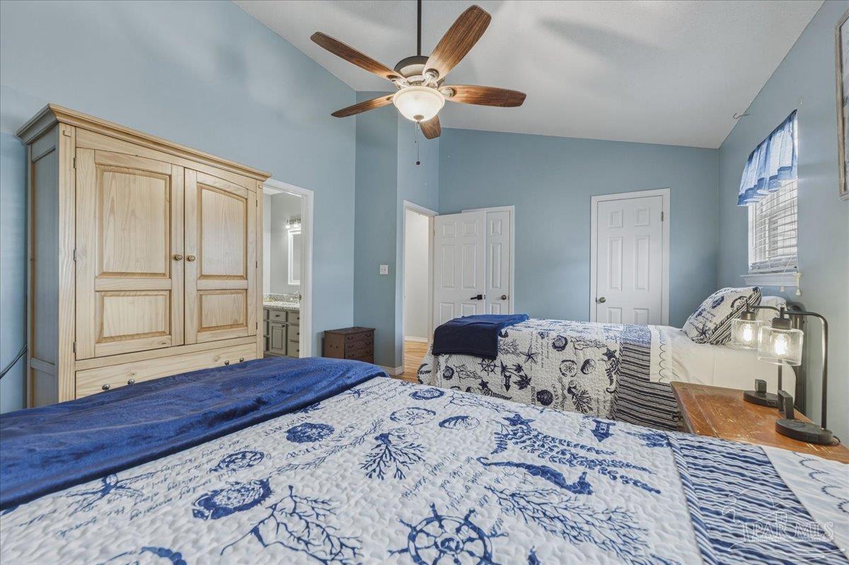 26063 Canal Road, Unit 3F Orange Beach, AL 36561 - Photo 58 of 72 a bedroom with a bed ceiling fan and a window
