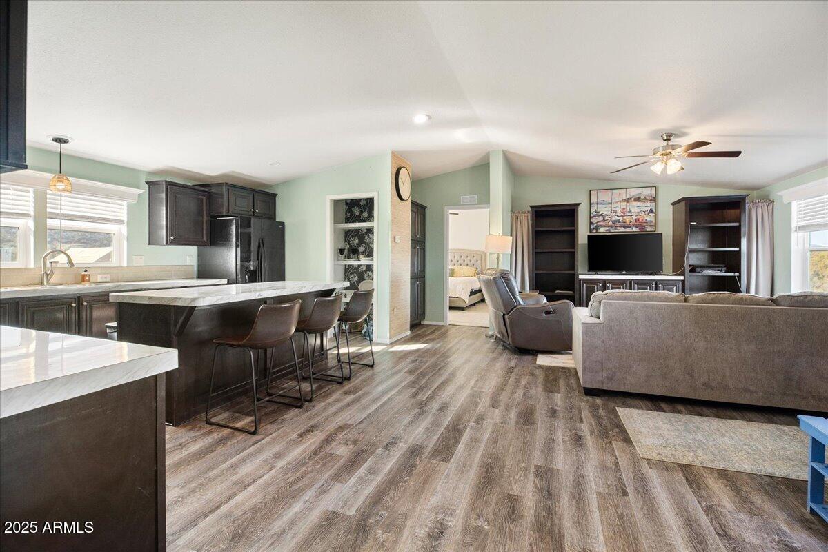 3145 Fort Verde Trail Rimrock, AZ 86335 - Photo 3 of 12 a living room with stainless steel appliances kitchen island granite countertop a couch and a large window