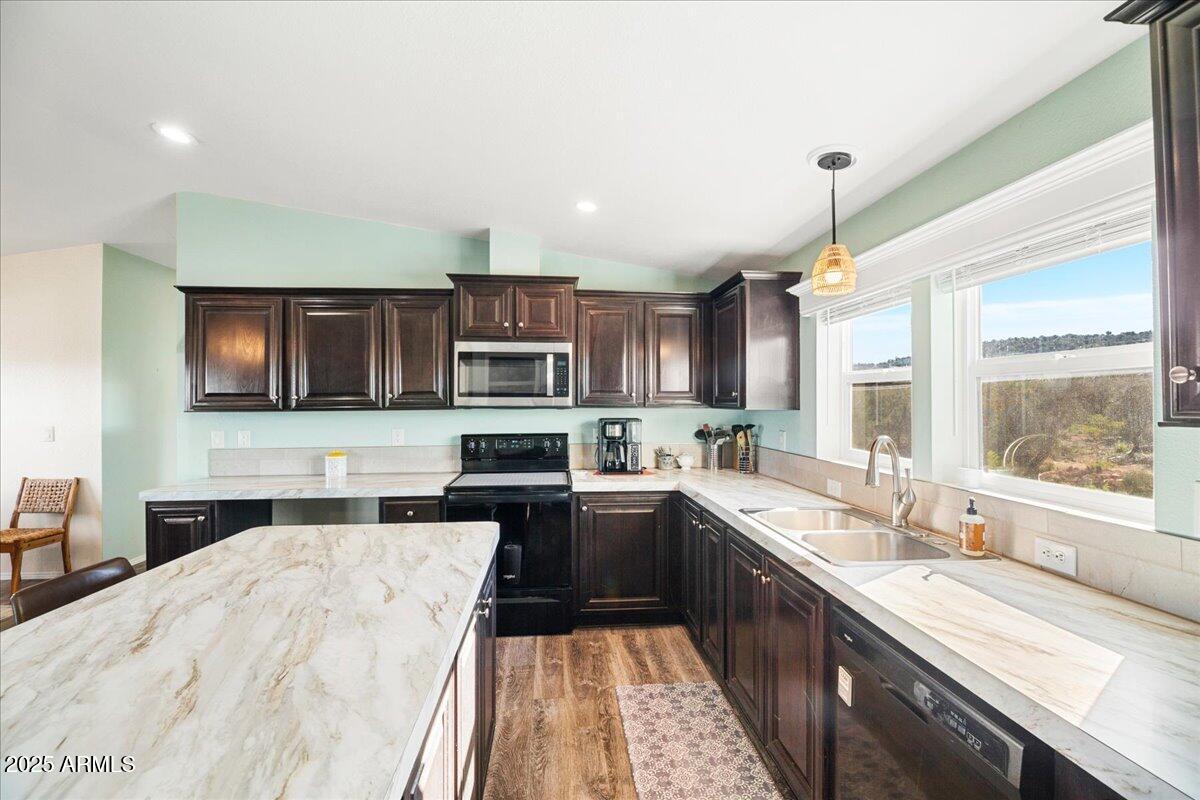 3145 Fort Verde Trail Rimrock, AZ 86335 - Photo 6 of 12 a kitchen with stainless steel appliances a sink stove and cabinets