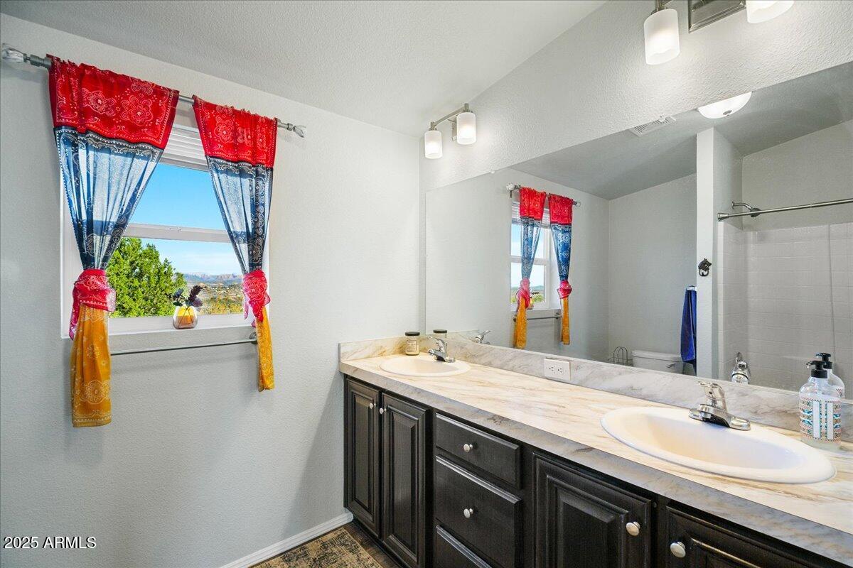 3145 Fort Verde Trail Rimrock, AZ 86335 - Photo 9 of 12 a bathroom with a sink vanity and a mirror
