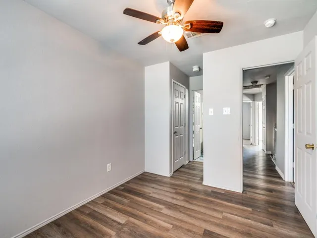 a view of an empty room and wooden floor