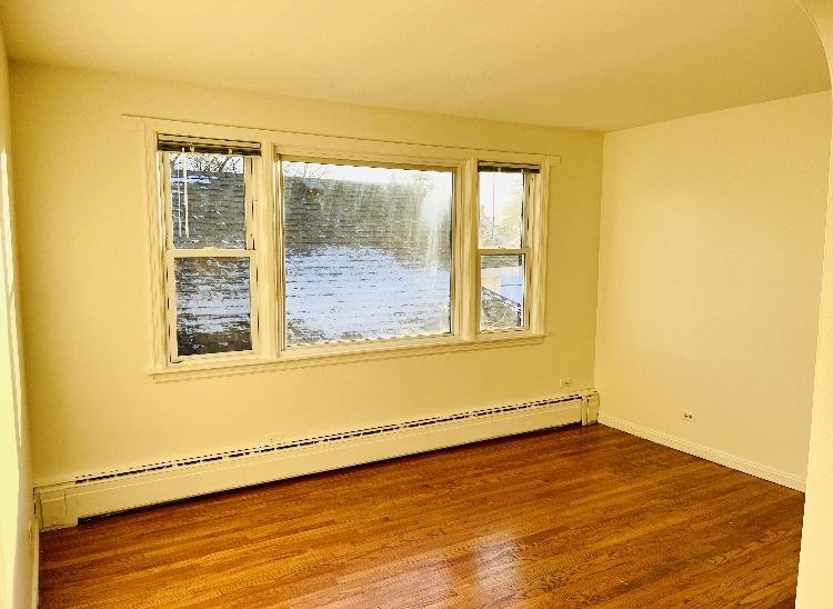 3726 Home Avenue, Unit 2 Berwyn, IL 60402 - Photo 2 of 7 a view of an empty room with wooden floor and a window