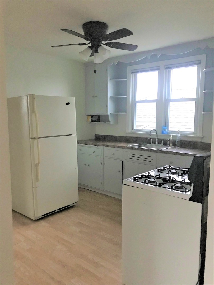 3726 Home Avenue, Unit 2 Berwyn, IL 60402 - Photo 3 of 7 a kitchen with a cabinets a sink a window and a stainless steel appliances