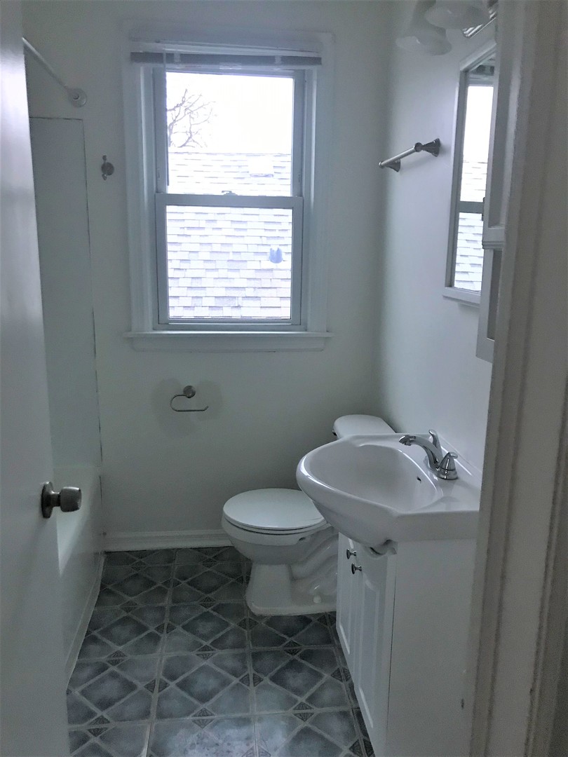 3726 Home Avenue, Unit 2 Berwyn, IL 60402 - Photo 7 of 7 a bathroom with a sink toilet and a window