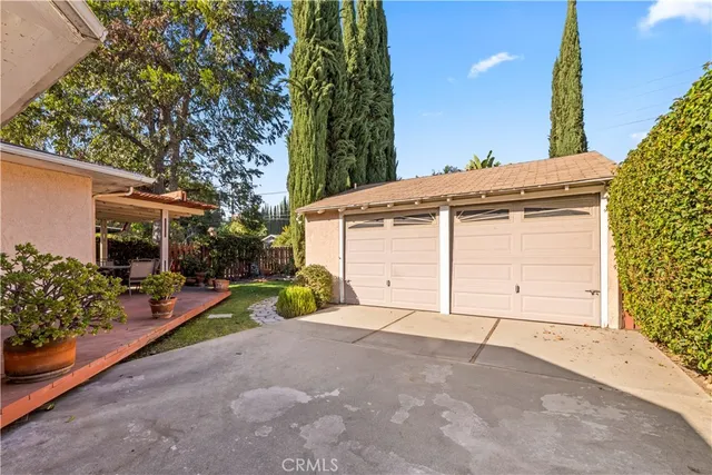 a view of a bedroom with wooden floor and window
