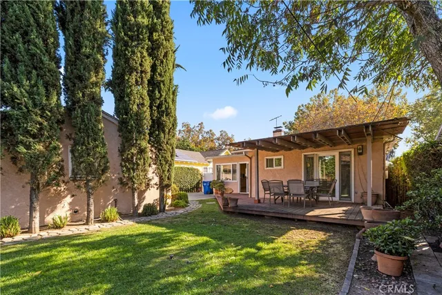 a view of a house with backyard porch and sitting area