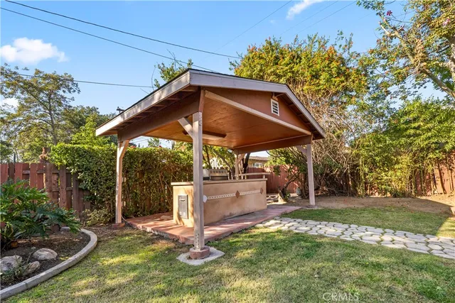 a view of a backyard with table and chairs and a fire pit