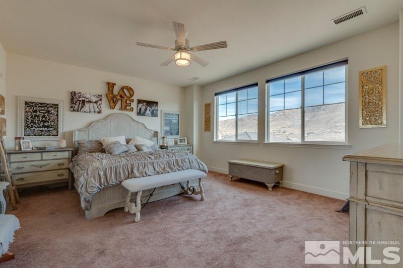10602 Washington Reno, NV 89521 - Photo 16 of 25 a bedroom with a bed and a chandelier