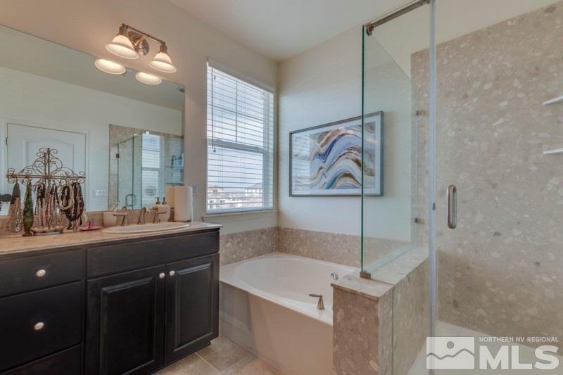 10602 Washington Reno, NV 89521 - Photo 18 of 25 a bathroom with a sink a vanity and a bathtub