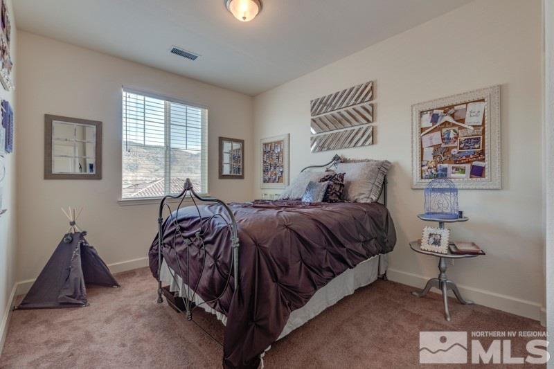 10602 Washington Reno, NV 89521 - Photo 20 of 25 a spacious bedroom with a bed and a painting on the wall