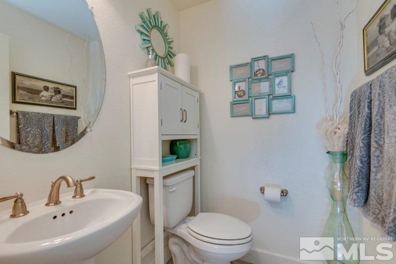 10602 Washington Reno, NV 89521 - Photo 8 of 25 a bathroom with a toilet sink and mirror