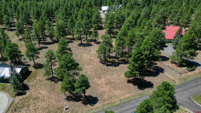 an aerial view of residential house with yard and outdoor seating