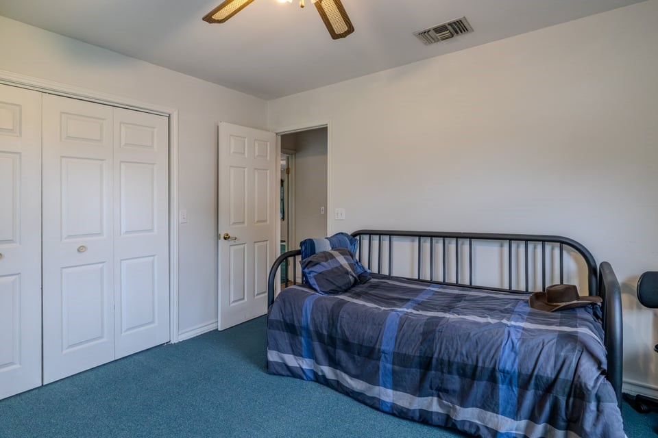 483 Riverside Drive Palacios, TX 77465 - Photo 15 of 41 a bedroom with a bed and wooden floor