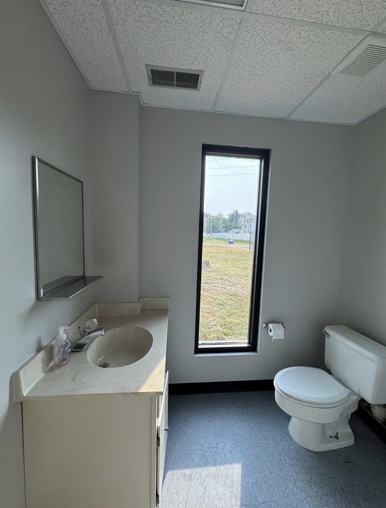 4709 Mueller Brass Road Covington, TN 38019 - Photo 5 of 10 a bathroom with a toilet sink and mirror