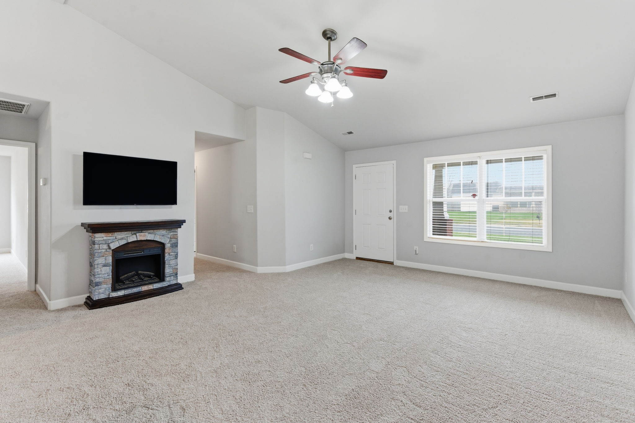 2036 Sparrow Street Spring Hill, TN 37174 - Photo 3 of 25 an empty room with fireplace fan and windows