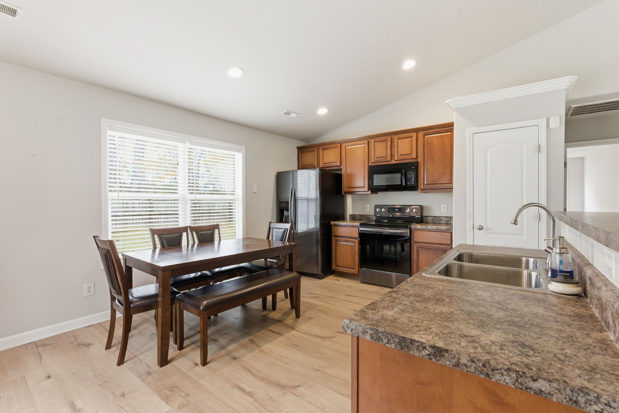 2036 Sparrow Street Spring Hill, TN 37174 - Photo 5 of 25 a kitchen with a stove a sink and a refrigerator