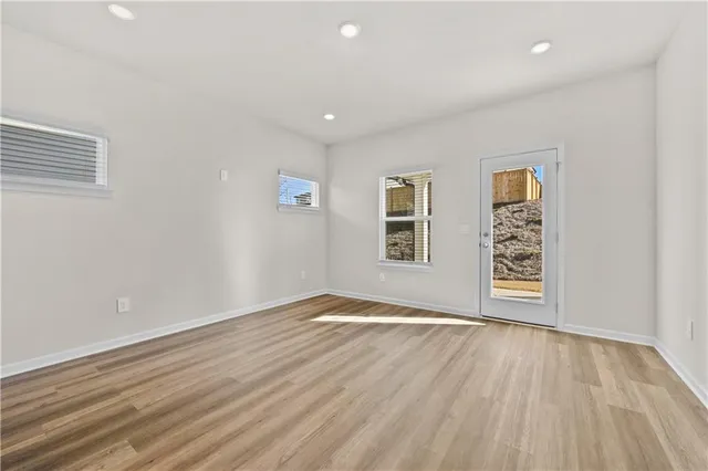 a view of kitchen with stainless steel appliances granite countertop cabinets and wooden floor
