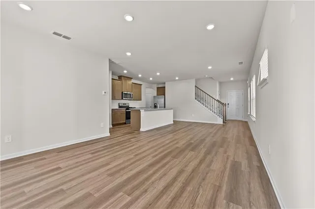 a kitchen with stainless steel appliances granite countertop a refrigerator and a stove top oven