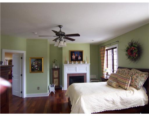 296 McCombs Road Venetia, PA 15367 - Photo 10 of 18 Master Bedroom. Cherry hardwood flooring and a gas fiireplace make the master suite warm and cozy. Plenty of windows for natural lighting accented by a ceiling fan.